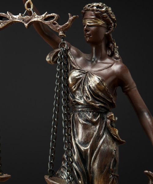 bronze-statuette-with-scales-of-justice-isolated-o-253MJCL.jpg